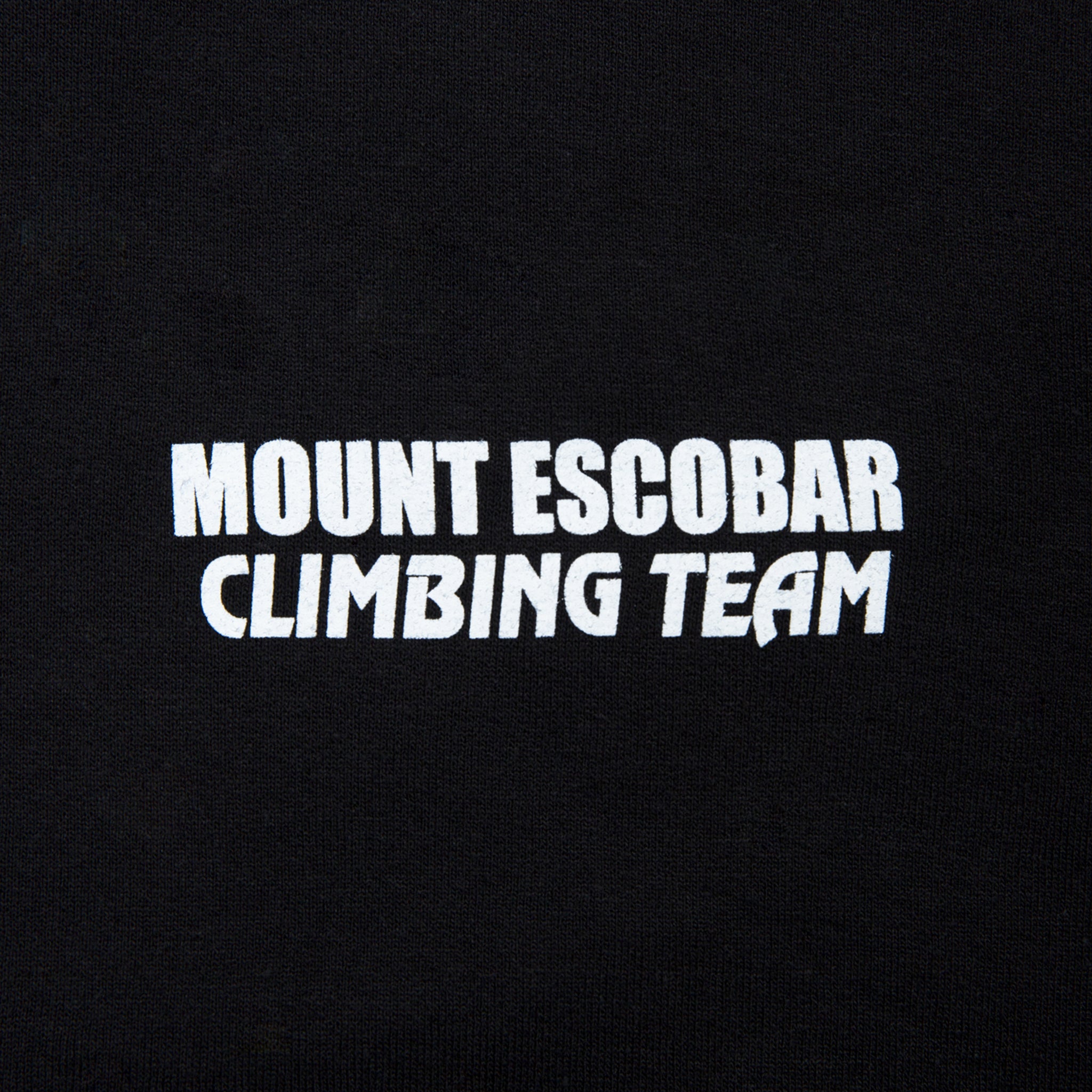 Close-up view of front graphic print of Made in Paradise World Drug Trade Collection "MOUNT ESCOBAR" black hoodie