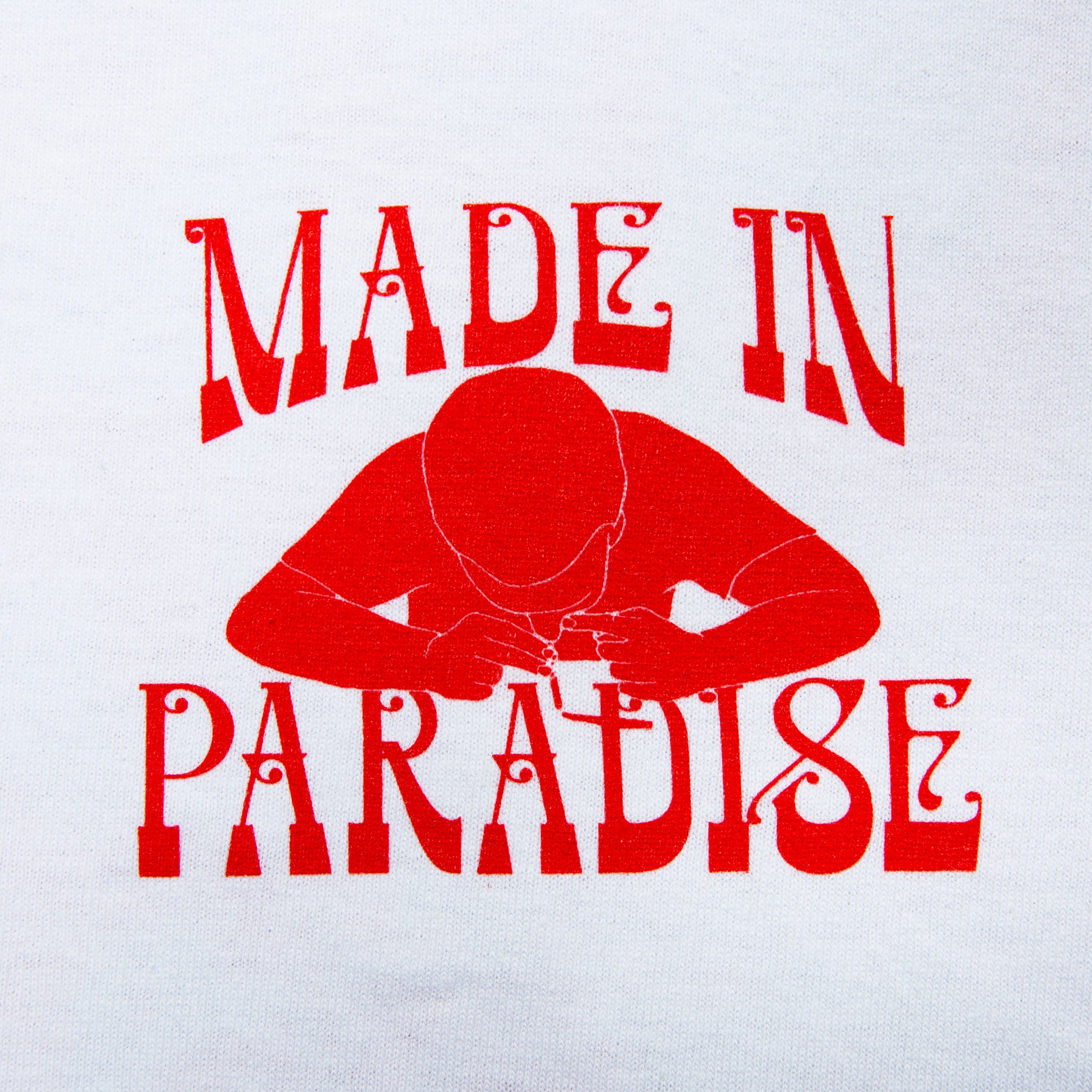 Close-up view of front graphic print of Made in Paradise World Drug Trade "COCAINE PRICES" white short sleeve t-shirt