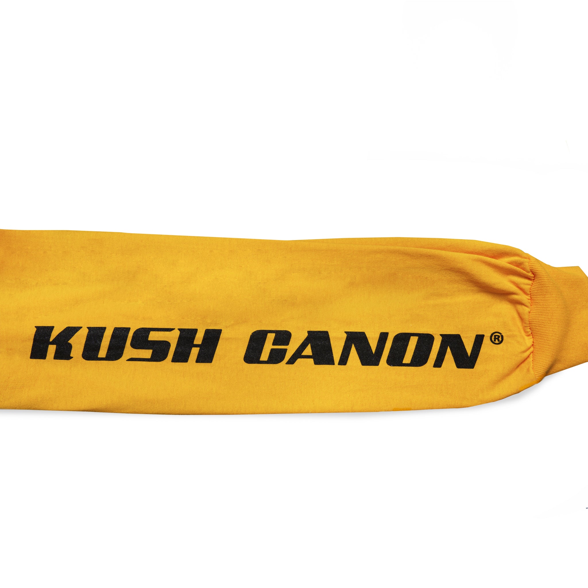 Close-up view of sleeve graphic print of Made in Paradise World Drug Trade Collection "KUSH CANON" yellow long sleeve t-shirt