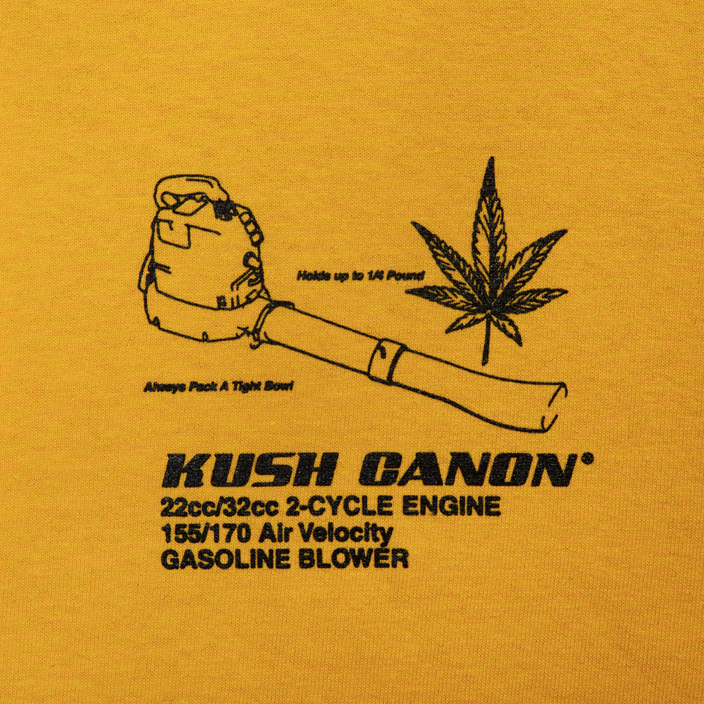 Close-up view of front graphic print of Made in Paradise World Drug Trade Collection "KUSH CANON" yellow long sleeve t-shirt