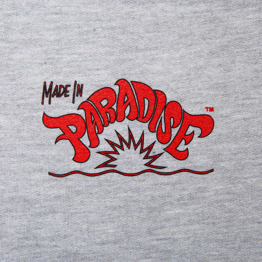 Close-up view of front graphic print of Made in Paradise World Drug Trade Collection "WORLD DRUG TRADE" sport grey crewneck